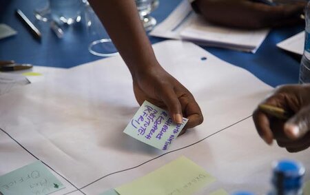 Sticky note being placed on a piece of paper