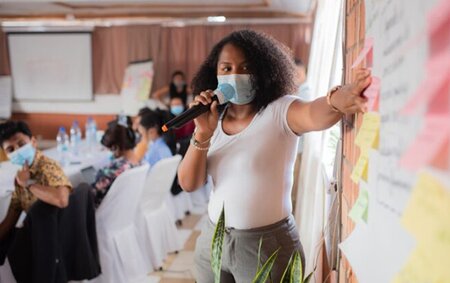 Woman presenting project on whiteboard